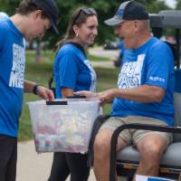 Volunteer grabbing snack from bin